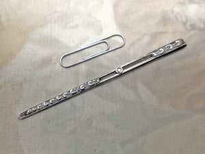 A silver tweezer / bodkin combination piece. for use when sewing.