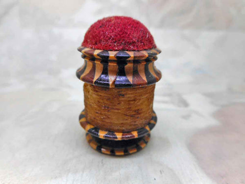 A Tunbridge Ware thread waxer and emery cushion in combination-an antique sewing tool.