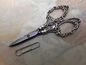 A pair of silver handled scissors. HM. Birmingham 1896 L&S.