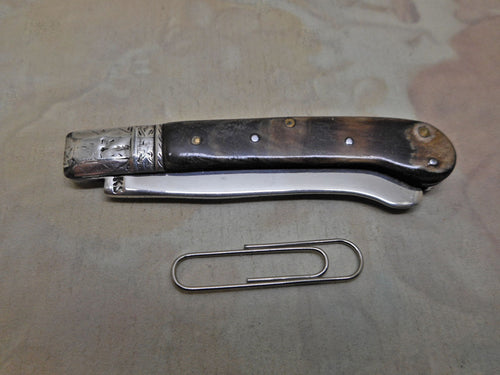 An 18th century folding fruit knife with scimitar blade and pistol grip handle.