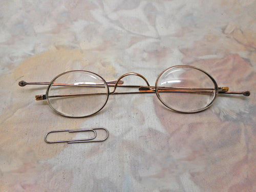 A pair of gold oval lens spectacles / eye glasses. c1900