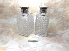 Charger l&#39;image dans la galerie, A pair of cut-glass scent bottles with screw on silver lids. c 1860
