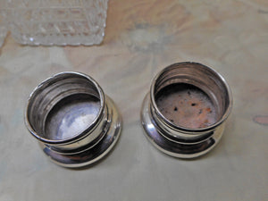 A pair of cut-glass scent bottles with screw on silver lids. c 1860