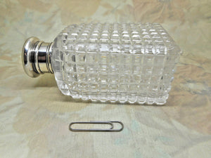 A pair of cut-glass scent bottles with screw on silver lids. c 1860