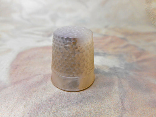 A carved mother of pearl thimble. 19th century.