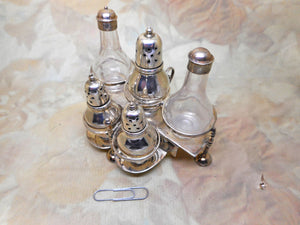 A miniature sterling silver cruet made to an 18th century design.