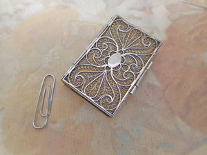 An antique silver filigree needle case in the form of a book. c 1800