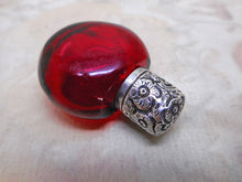 Load image into Gallery viewer, An antique ruby glass scent bottle with an embossed silver cap. 19th century.
