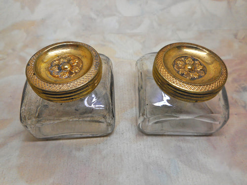 A pair of ink wells with decorative gilded lids. Mid 19th century.