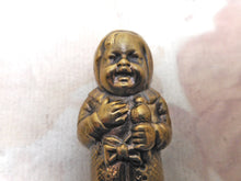 Load image into Gallery viewer, A brass match safe / vesta in the form of a baby. c 1900-1920
