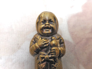 A brass match safe / vesta in the form of a baby. c 1900-1920