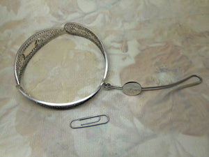 A 19th century Dutch silver filigree bangle and wool hook.