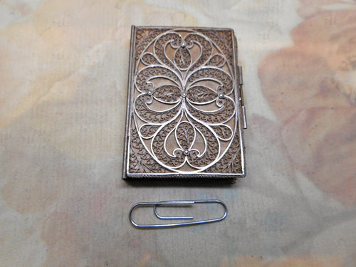 An antique silver filigree needle case in the form of a book. c 1800-1815