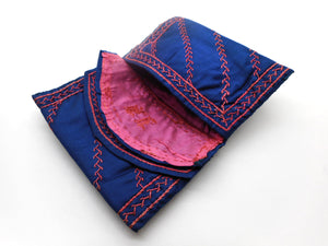 An embroidered blue silk wallet dated 1892.