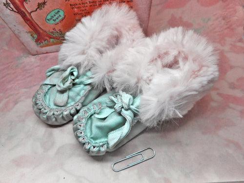 A pair of baby's shoes with fur trim. 20thc