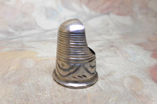 Load image into Gallery viewer, A silver finger guard which is a type of thimble dated 1906
