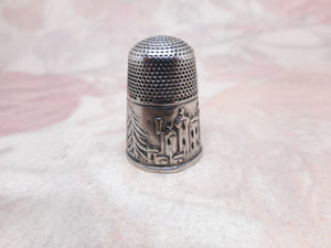 A silver thimble with an embossed image of Windsor Castle circa 1850