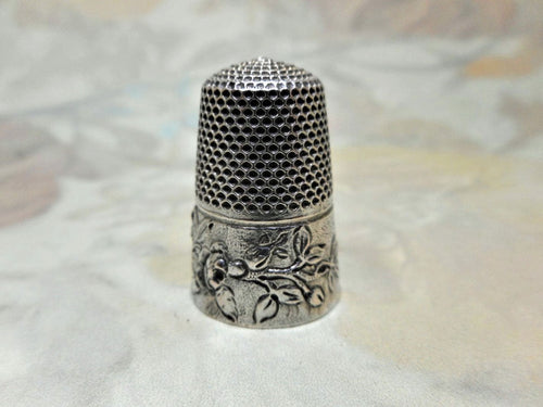 A French silver thimble embossed with roses. c 1890